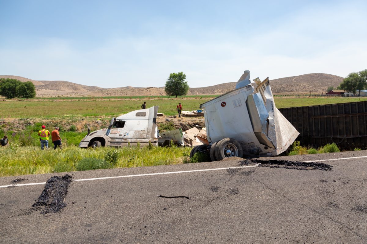 In a devastating sideswipe crash between a school bus and a big rig, two families filed wrongful death lawsuits against the trucker, his company, and its owner.